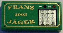 Part 3069pb0031 - Tile 1 x 2 with Gold 'FRANZ JÄGER', '2003', and Silver Numeric Keypad Pattern - De BrickPlaats