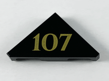 Part 35787pb004 - Tile, Modified 2 x 2 Triangular with Gold '107' Pattern - De BrickPlaats
