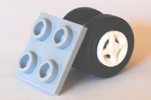 Part 4870c04 - Plate, Modified 2 x 2 Thin with Dual Wheels Holder - Split Pins with White Wheels and Black Tires (4870 / 4624 / 59895) - De BrickPlaats