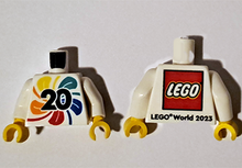 Part 973pb5462c01 - Torso LEGO World 2023 with Swirl of Colors and Number 20 Pattern / White Arms / Yellow Hands - De BrickPlaats